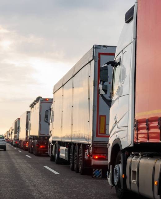 Queue of Trucks on Ukraine-Poland Border traffic jam at Sunset During Protest Roadblock. Business agricultural Logistics blockade action. Cargo lorry semi-trailers stuck.